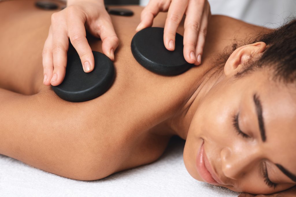 Massage Treatments 5 closeup of black lady having healing hot stone mas 2023 11 27 05 17 58 utc - LondonMassage4U